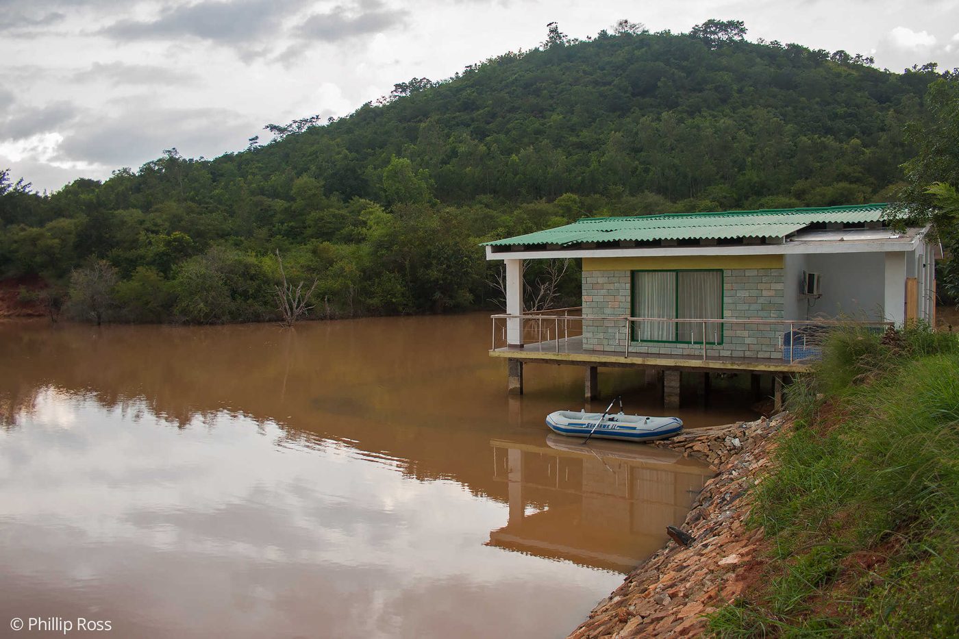 A view across the water at The Outback Farm and Homestay, with the verandah in the foreground