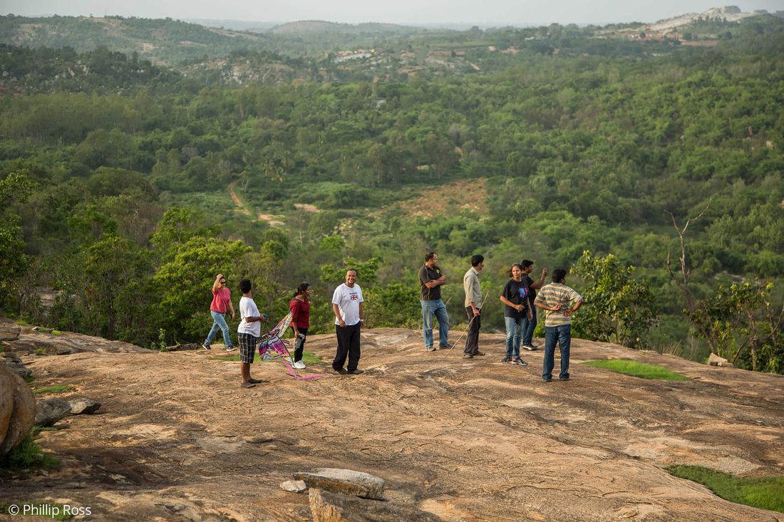 Walkers on a trek looking out over the forested landscape at Bannerghatta